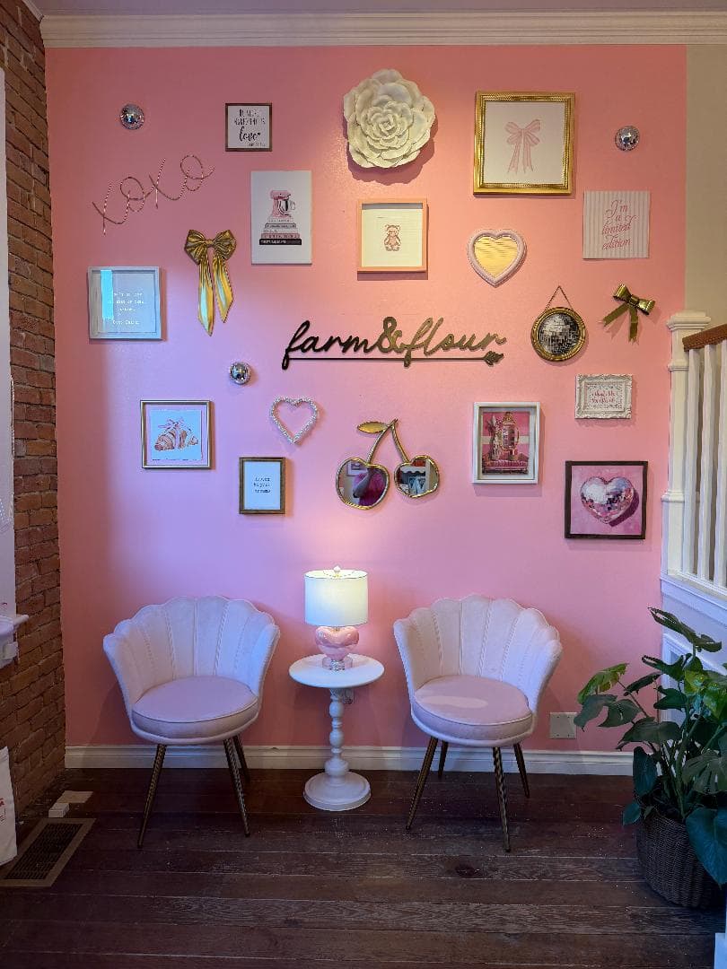 Pink gallery wall and seating inside the Farm & Flour bakery boutique